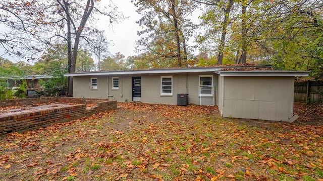 rear view of house featuring central air condition unit