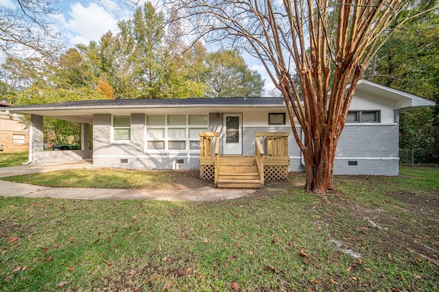 ranch-style home featuring a carport and a front yard