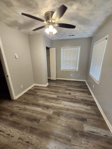 unfurnished bedroom with dark hardwood / wood-style flooring and ceiling fan