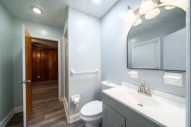 bathroom with hardwood / wood-style floors, vanity, and toilet