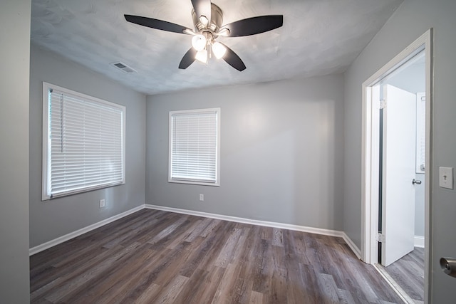 unfurnished room with ceiling fan, dark hardwood / wood-style flooring, and a textured ceiling