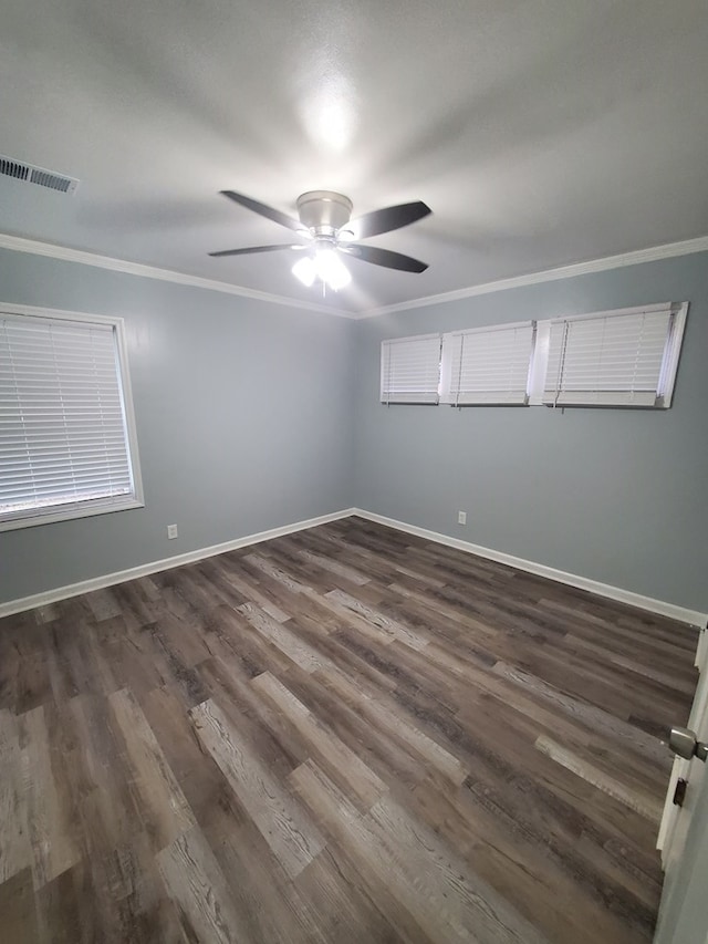 unfurnished room featuring dark hardwood / wood-style floors, ceiling fan, and ornamental molding