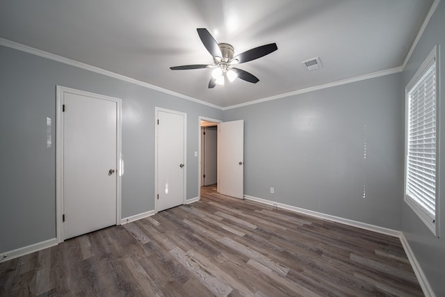 unfurnished bedroom featuring crown molding, ceiling fan, and dark wood-type flooring