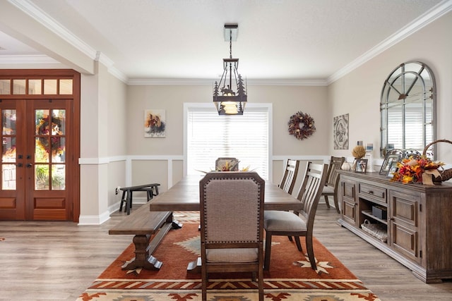 dining area featuring french doors, a healthy amount of sunlight, and light hardwood / wood-style floors