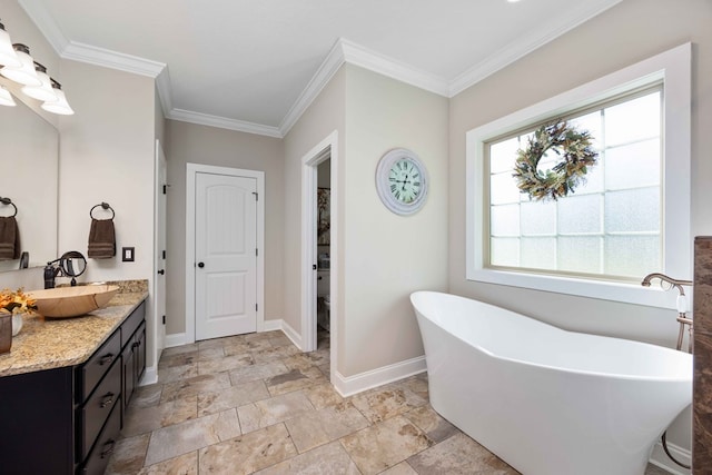 bathroom featuring a bathing tub, crown molding, and vanity