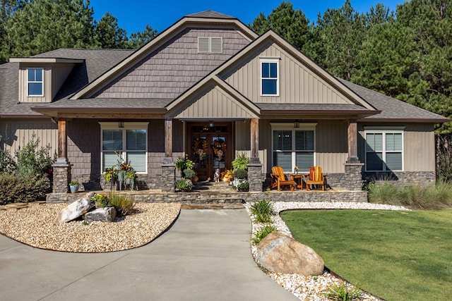 craftsman-style house with a front lawn and a porch