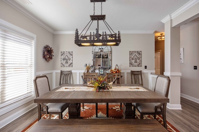 dining area featuring a chandelier, dark hardwood / wood-style flooring, plenty of natural light, and ornamental molding