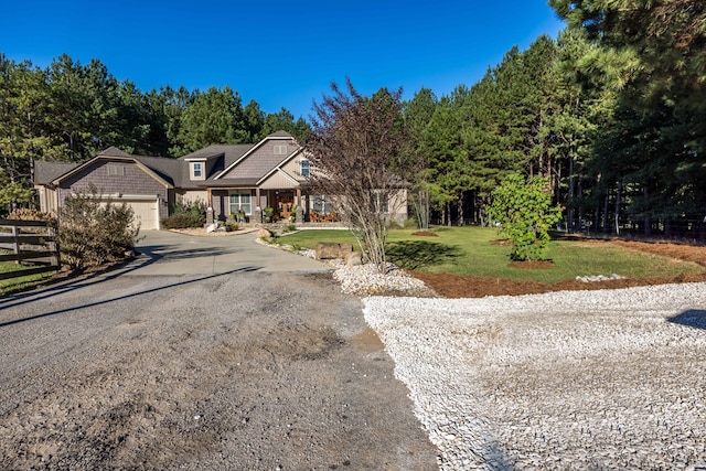 view of front of house featuring a garage and a front lawn