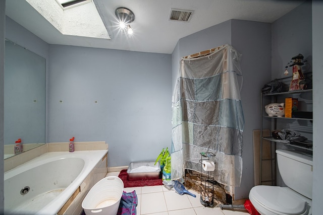6831 Raintree Dr, Columbus, GA 31909 - bathroom featuring a skylight, toilet, tile patterned flooring, and a jetted tub