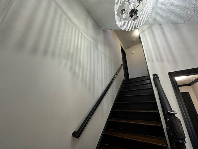 stairs with a textured ceiling