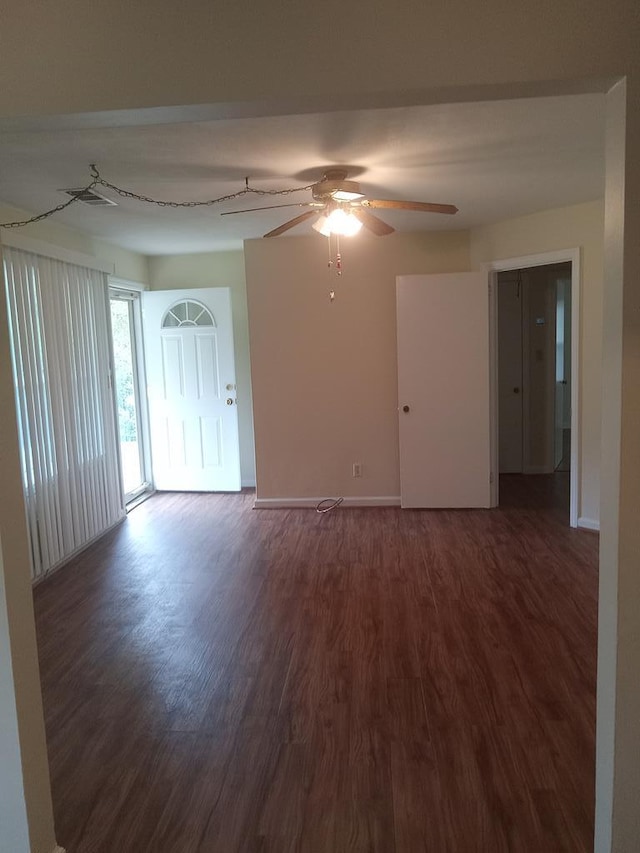 empty room featuring dark hardwood / wood-style flooring and ceiling fan