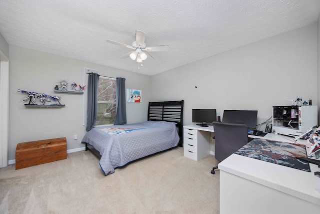 bedroom featuring light carpet, ceiling fan, baseboards, and a textured ceiling