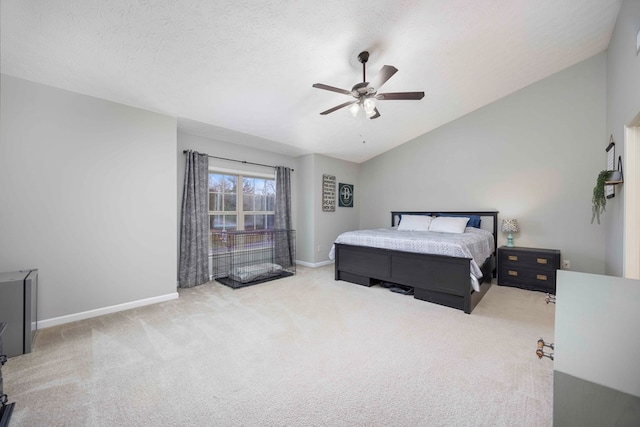 bedroom with carpet floors, a ceiling fan, vaulted ceiling, a textured ceiling, and baseboards