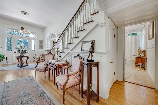 staircase with a notable chandelier and hardwood / wood-style floors