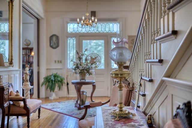 entryway featuring a notable chandelier, hardwood / wood-style floors, and a wealth of natural light