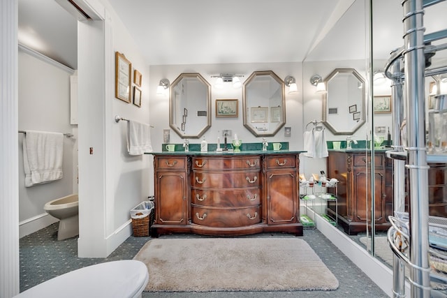 bathroom featuring a bidet, vanity, and toilet