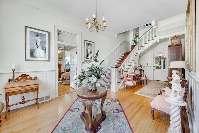 entryway featuring an inviting chandelier and light hardwood / wood-style floors