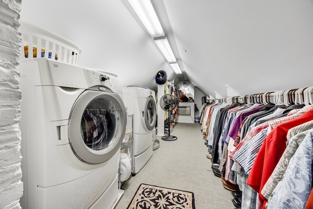 laundry area with light colored carpet and washer and clothes dryer