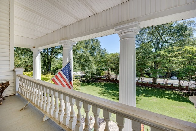 deck with a porch and a lawn