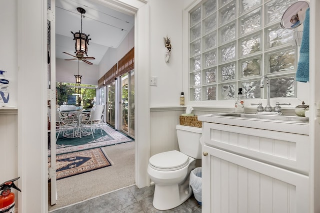 bathroom featuring tile patterned flooring, vanity, ceiling fan, and toilet