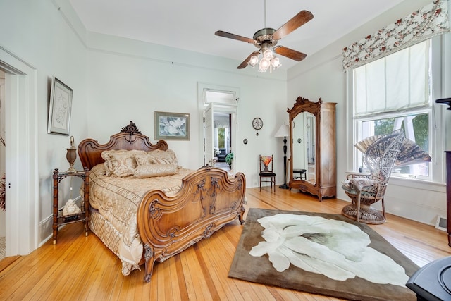 bedroom with ceiling fan and light hardwood / wood-style flooring