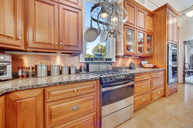 kitchen with stainless steel appliances and light stone countertops