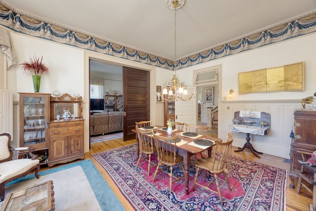 dining room featuring hardwood / wood-style flooring and a notable chandelier