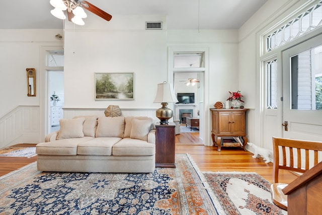 living room featuring hardwood / wood-style floors and ceiling fan