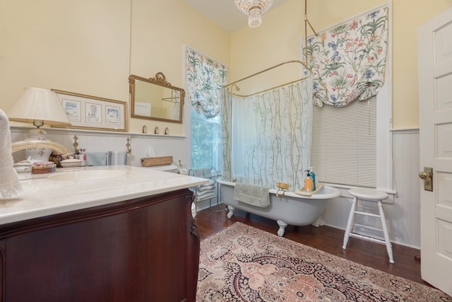 bathroom featuring vanity, hardwood / wood-style floors, and a bathtub