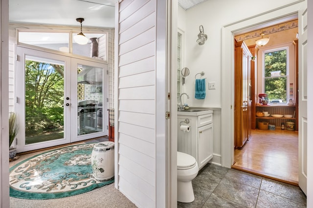 bathroom featuring french doors, vanity, and toilet