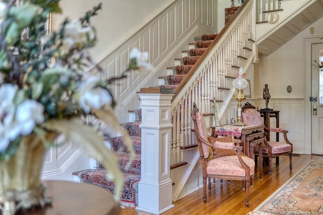 staircase with hardwood / wood-style floors