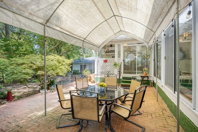 sunroom / solarium featuring vaulted ceiling