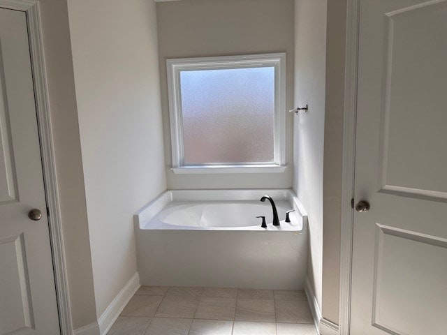 full bath featuring tile patterned flooring and a garden tub