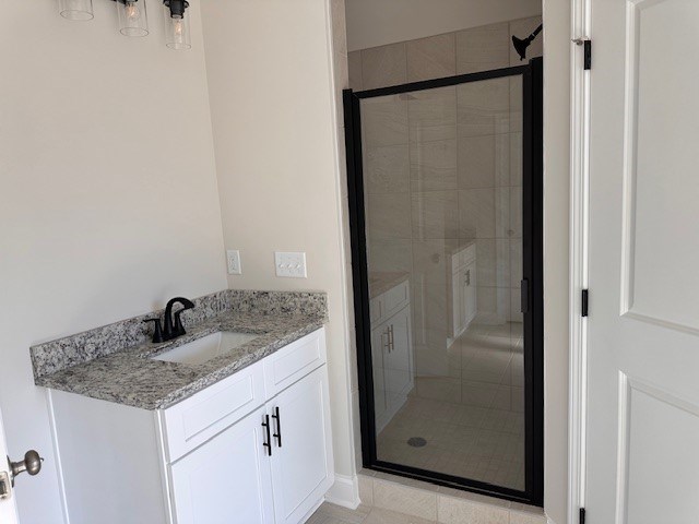 bathroom featuring vanity and a shower stall