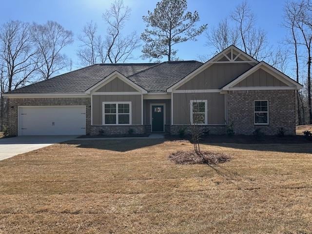 craftsman inspired home with brick siding, board and batten siding, a front yard, a garage, and driveway