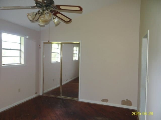 1469 Wall St, Richland, GA 31825 - unfurnished bedroom featuring wood-type flooring, baseboards, a closet, and a ceiling fan
