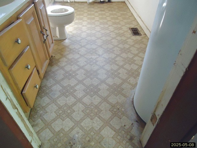 1469 Wall St, Richland, GA 31825 - bathroom featuring tile patterned floors, toilet, and vanity