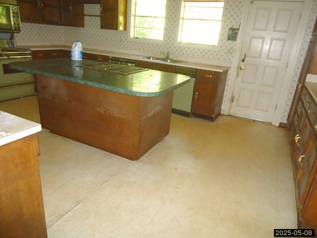 1469 Wall St, Richland, GA 31825 - kitchen with a sink, dishwasher, wall oven, a kitchen island, and light flooring