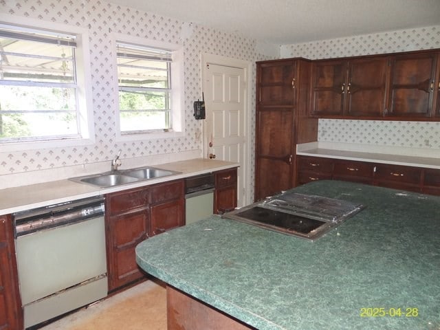 1469 Wall St, Richland, GA 31825 - kitchen featuring white dishwasher, a sink, wallpapered walls, and light countertops