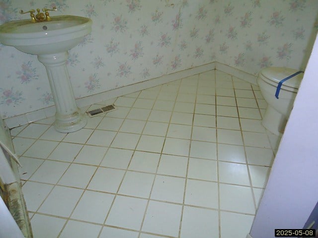 1469 Wall St, Richland, GA 31825 - bathroom with toilet, wallpapered walls, baseboards, and a sink