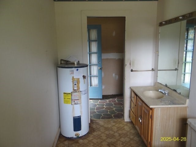 1469 Wall St, Richland, GA 31825 - bathroom featuring electric water heater, tile patterned floors, and vanity