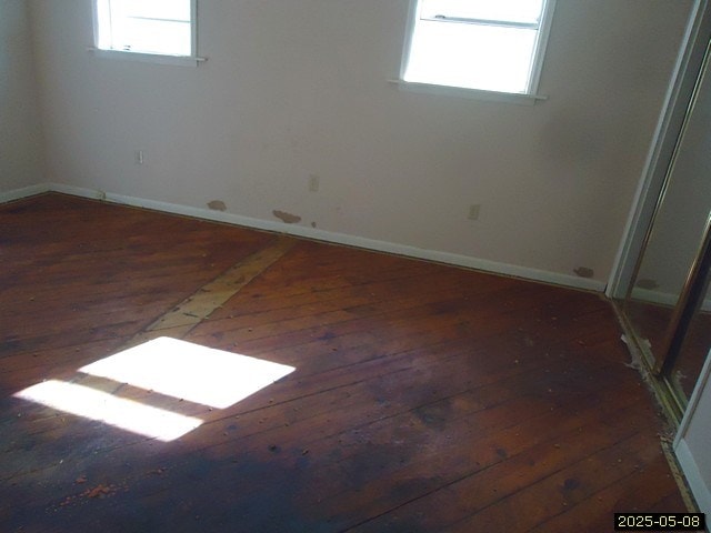 1469 Wall St, Richland, GA 31825 - unfurnished room featuring wood-type flooring, plenty of natural light, and baseboards