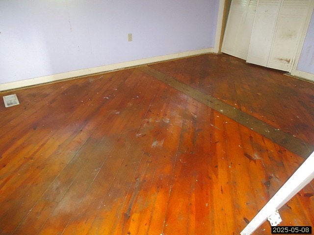 1469 Wall St, Richland, GA 31825 - unfurnished bedroom with hardwood / wood-style flooring and baseboards