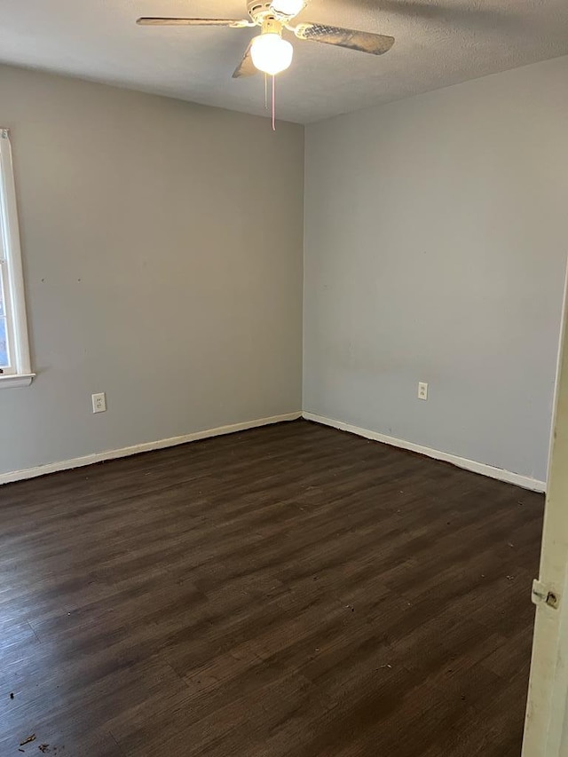 spare room with dark hardwood / wood-style floors, a textured ceiling, and ceiling fan