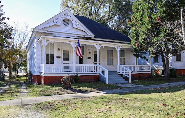 victorian home with a porch and a front lawn