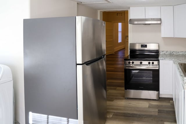 kitchen featuring white cabinets, light stone countertops, appliances with stainless steel finishes, dark hardwood / wood-style flooring, and washer / clothes dryer