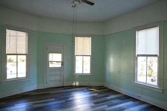 unfurnished room with dark hardwood / wood-style flooring and ceiling fan