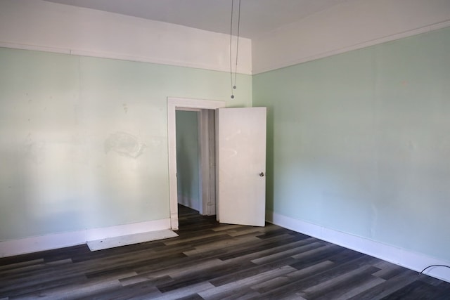 spare room featuring dark wood-type flooring