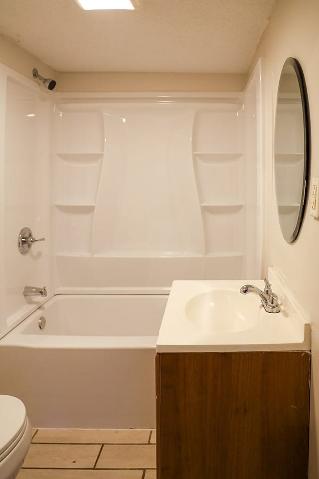 full bathroom with vanity, tile patterned flooring, toilet, a textured ceiling, and shower / bathtub combination