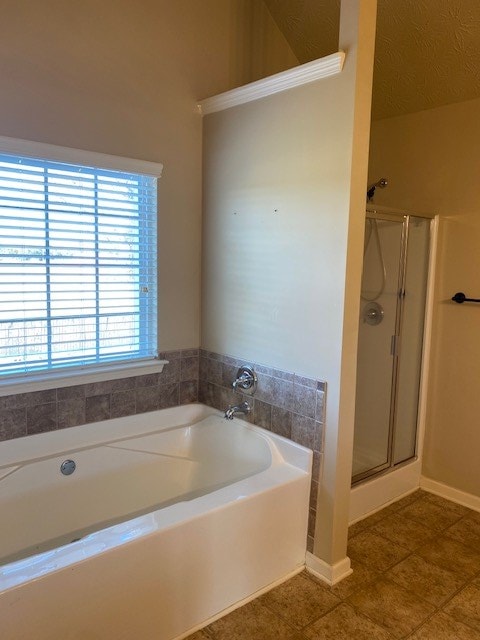 bathroom featuring plus walk in shower and tile patterned floors